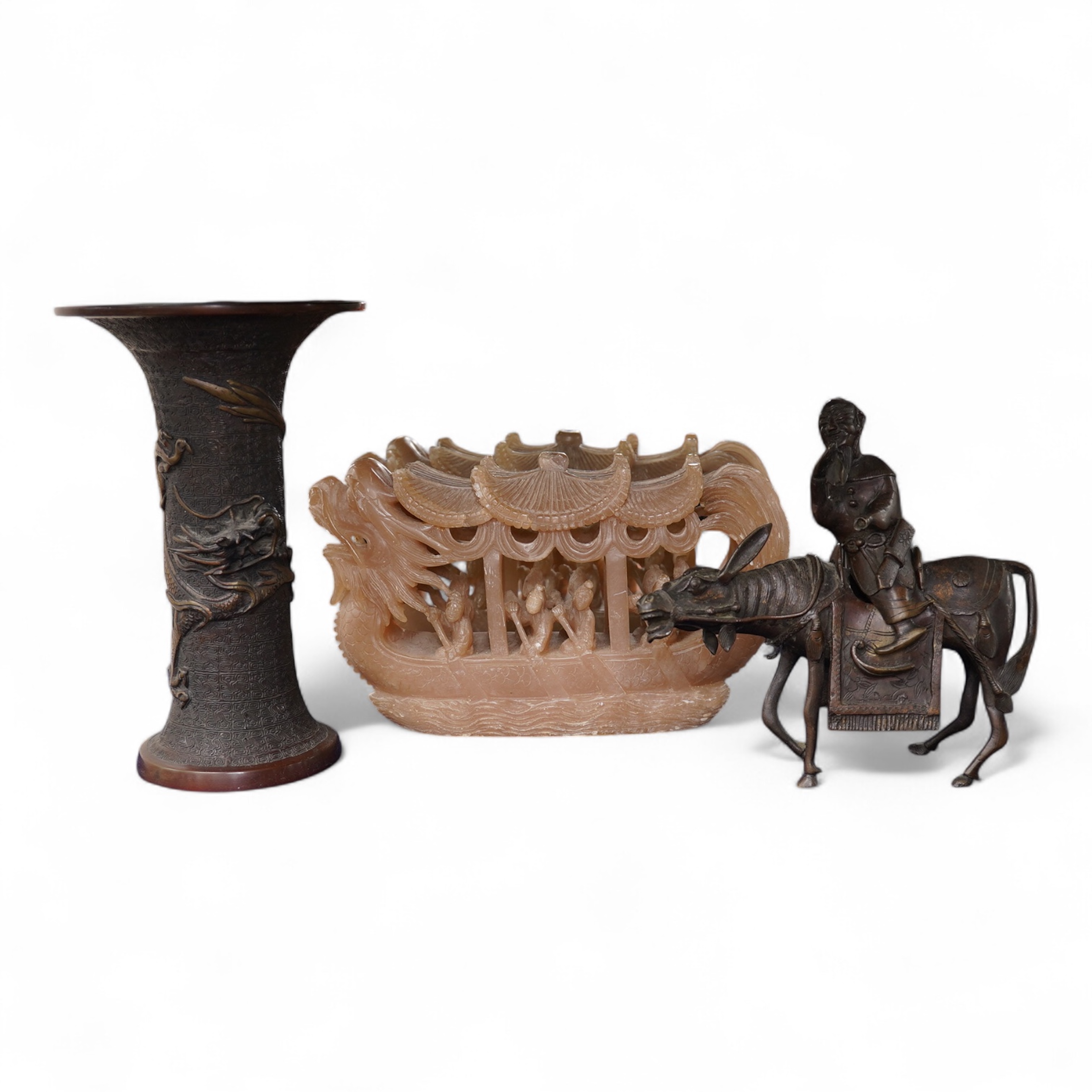 A Japanese bronze dragon vase, Chinese bronze immortal on donkey, and soapstone dragon boat carving, bronze vase 24cm high. Condition - good